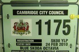 The green license plate on a private hire vehicle