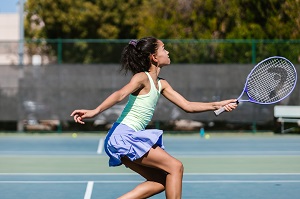 Child playing tennis