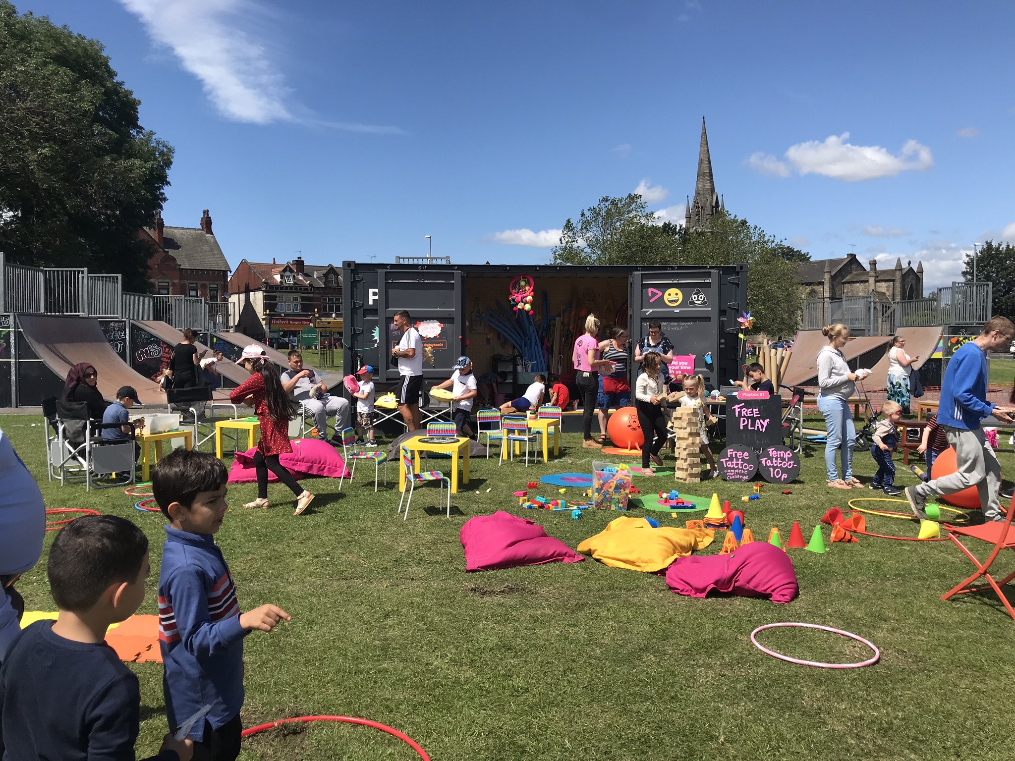 Playbox shipping container with lots of colourful games with beanbags, hoops, cones etc.