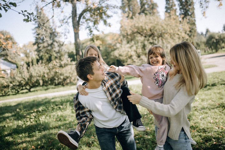 Parents carrying children outdoors