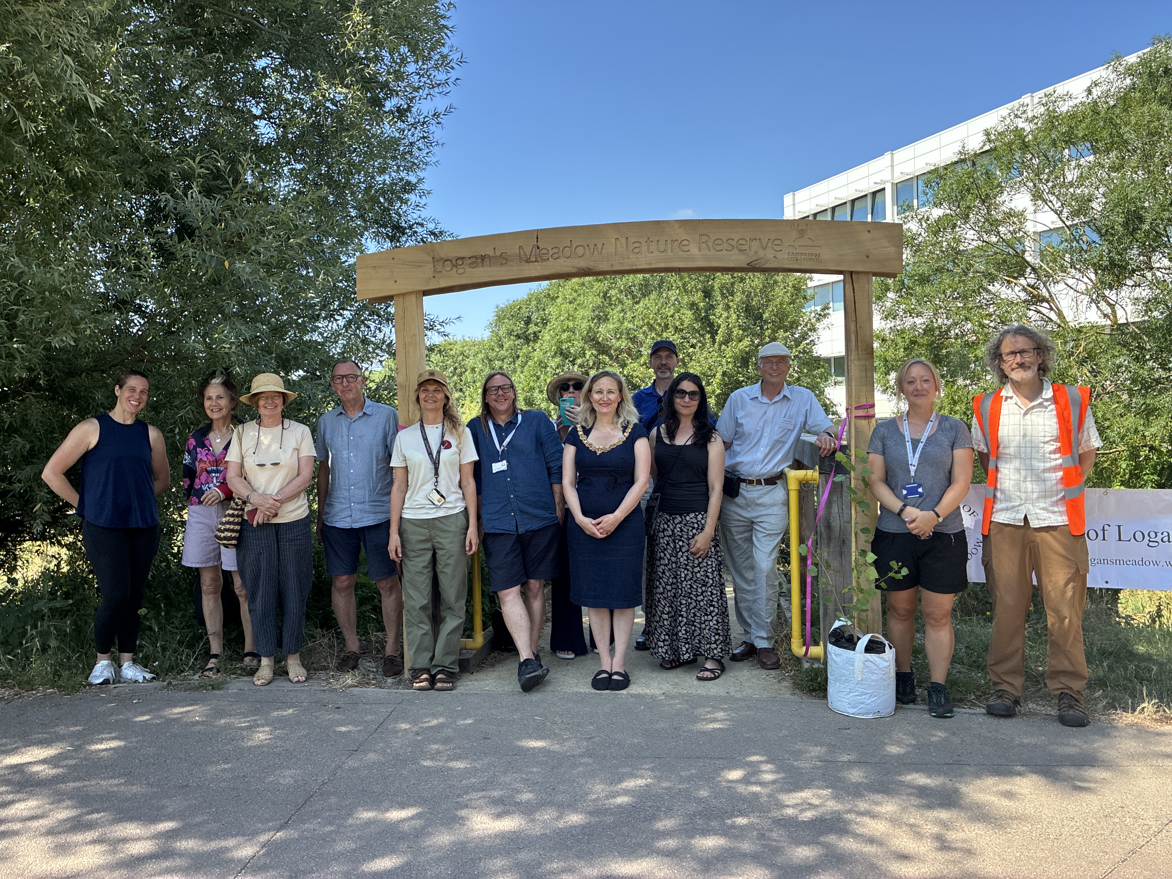 The Mayor of Cambridge with guests at the unveiling of a new wooden archway at Logan's Meadow local nature reserve in Cambridge