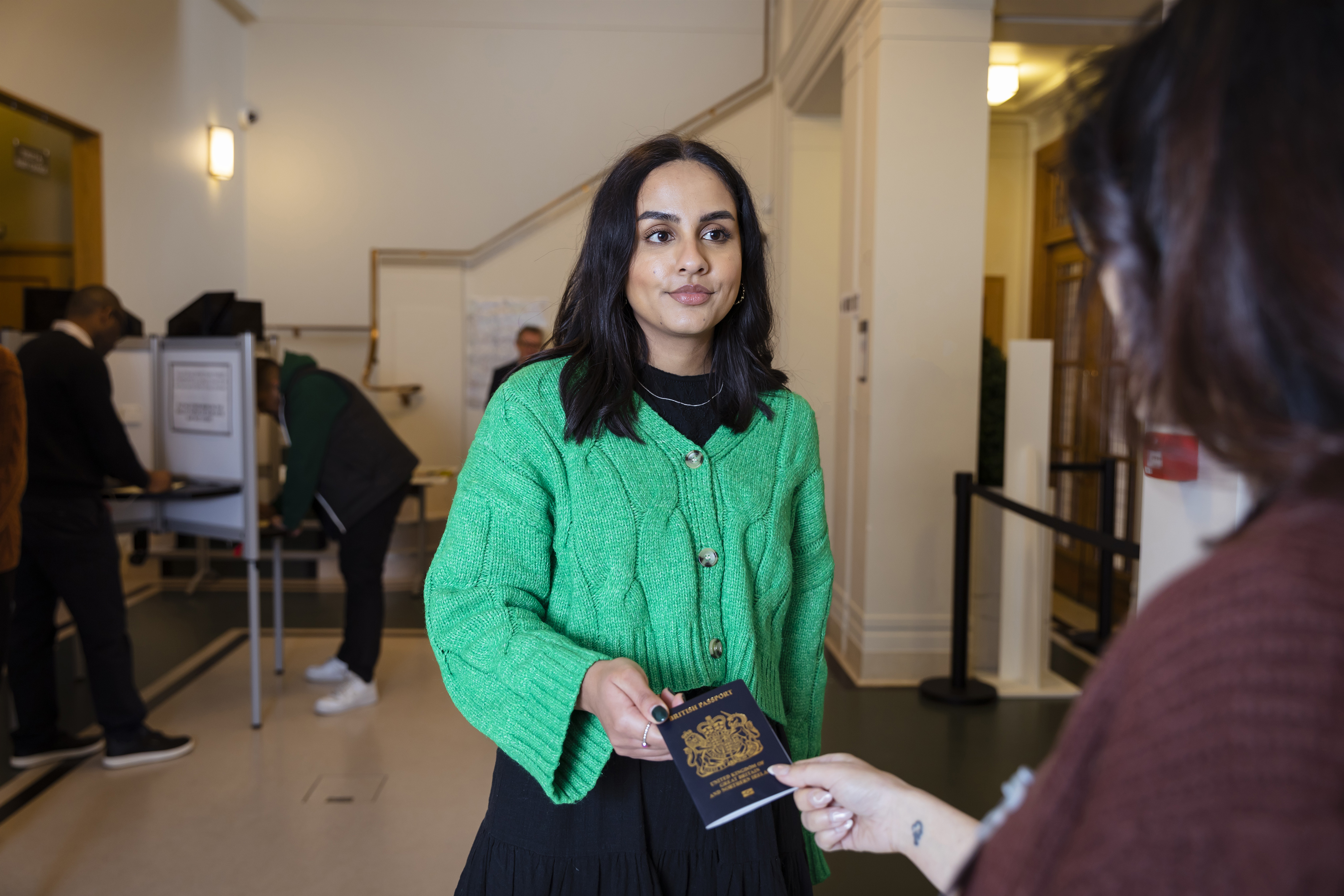 Person showing photo ID at polling station
