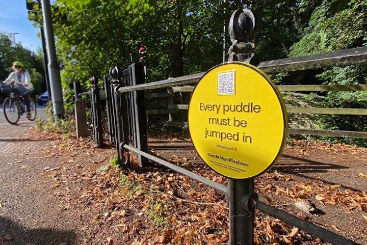 Playlaw sign declaring that "Every puddle must be jumped in”