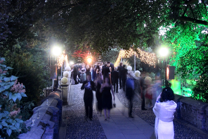 Attendees on the bridge over the River Cam at Clare College during a May Ball
