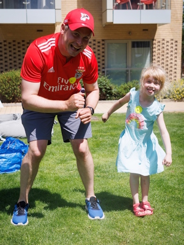 A father and daughter playing outside