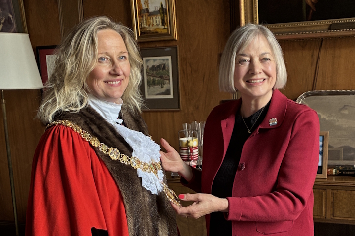 Mayor Maria Cleminson receiving the chain of office from the previous mayor, Dinah Pounds