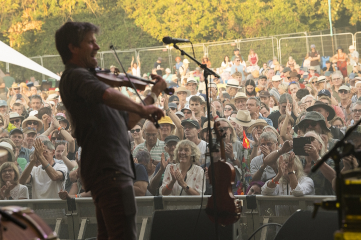 Violinist performing on stage at Cambridge Folk Festival 2026
